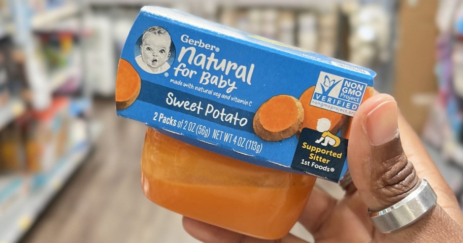 hand holding a pack of Gerber Baby Food in store