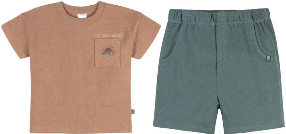 A brown Gerber Modern Moments toddler outfit featuring a short-sleeve t-shirt with a pocket, a sun-and-wave graphic, and "COOL VIBES EVERYDAY" text on the left, paired with green pull-on shorts on the right.