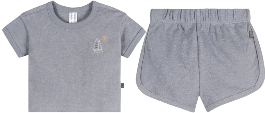 A grey Gerber Modern Moments toddler outfit featuring a short-sleeve t-shirt with a small sailboat and sun embroidery on the left and matching pull-on shorts on the right.