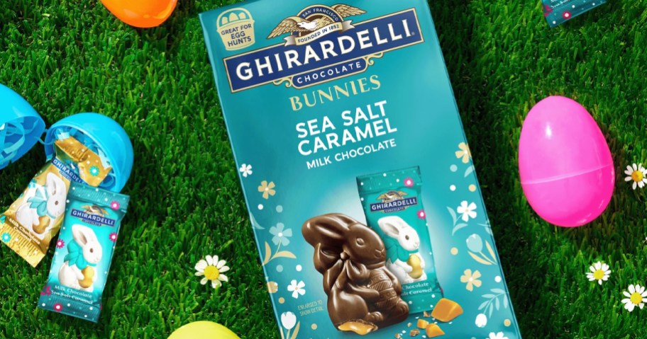 bag of Ghirardelli Chocolate Bunnies on grass near easter eggs
