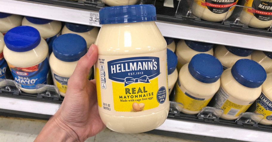 hand holding up a jar of Hellmann's Mayonnaise in store