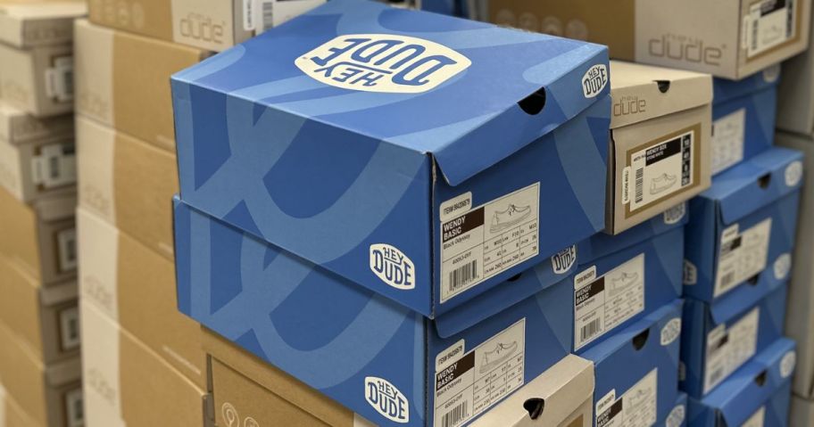 Stacks of HEYDUDE shoe boxes