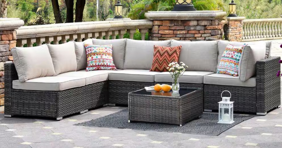 outdoor sectional with grey cushions and colorful pillows