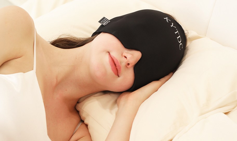 woman wearing a migraine sleep mask in bed