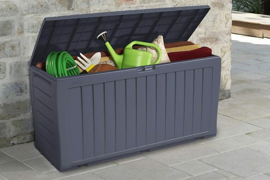 gardening supplies inside a grey deck box