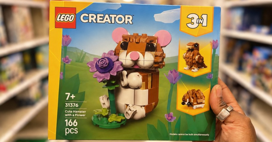 hand holding box to hamster lego set in store