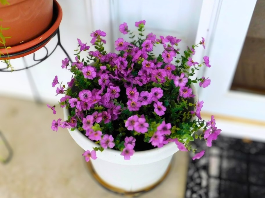 LetuoClips Artificial Flowers in purple sitting in outdoor pot on front porch