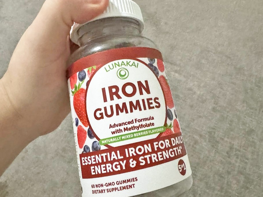hand holding up a bottle of Lunakai Iron Gummies