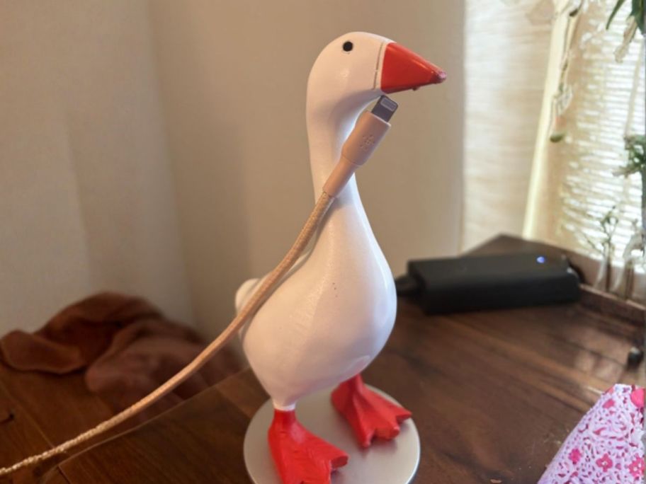 Magnetic Goose Key Holder with charging cord attached to beak on desk