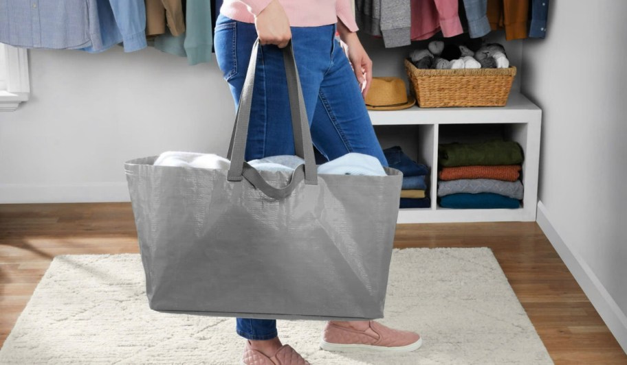 Woman carrying a gray Mainstays Storage Bag