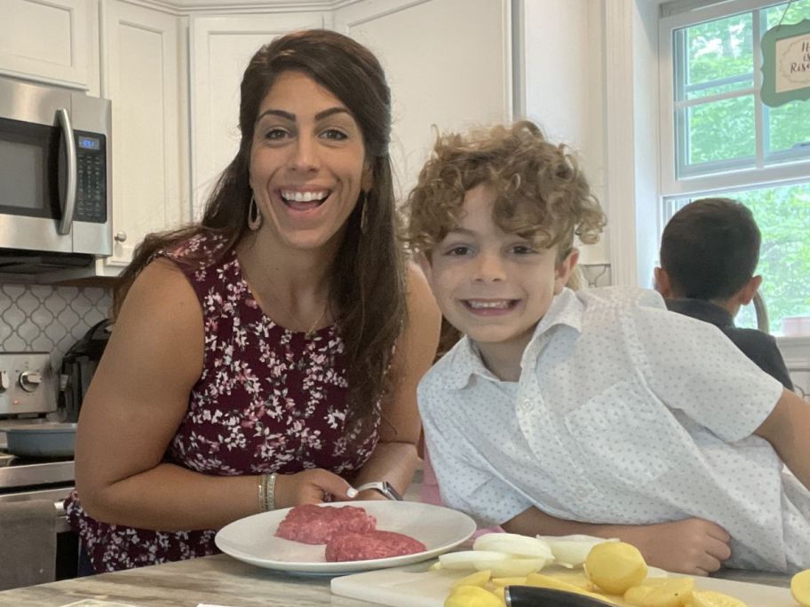A woman preparing a meal with a boy