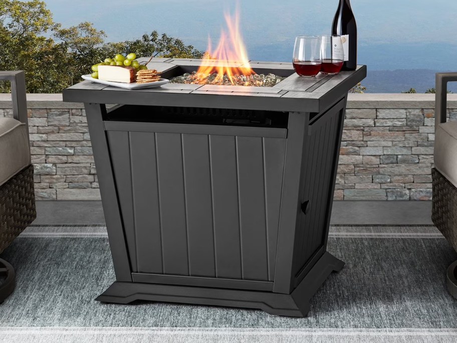 square gas fire pit with snacks and wine on top