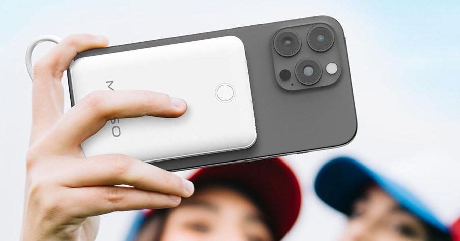 Miiso Power Bank in white being held by woman attached to her phone