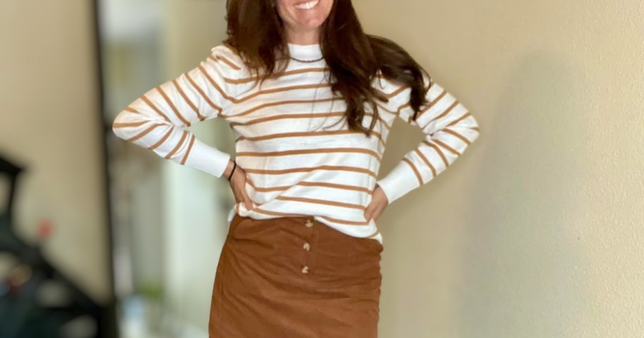 woman wearing striped puff sleeve sweater and skirt in brown