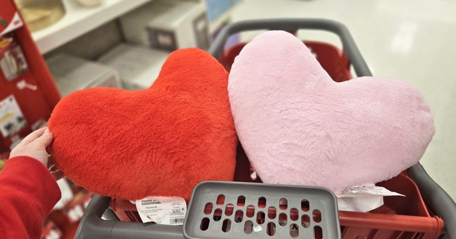 red and pink heart shaped pillows in a shopping cart
