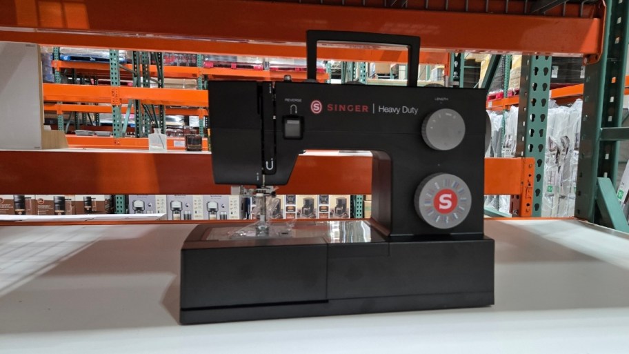 a black sewing machine on a store shelf