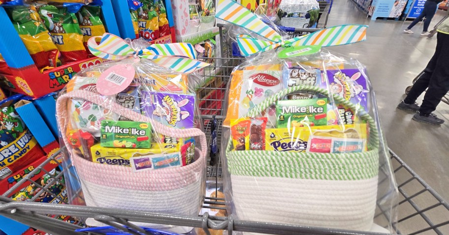 two pre-made easter baskets filled with candy in a shopping cart