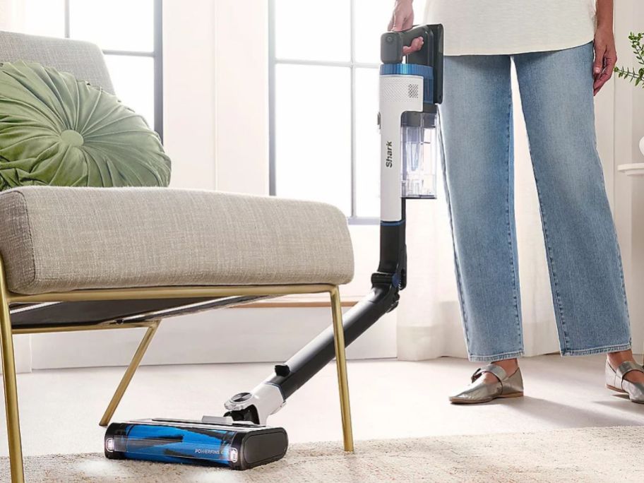woman using Shark CleanSense IQ Multi-Flex PowerFins IZ577 Cordless Vacuum underneath chair