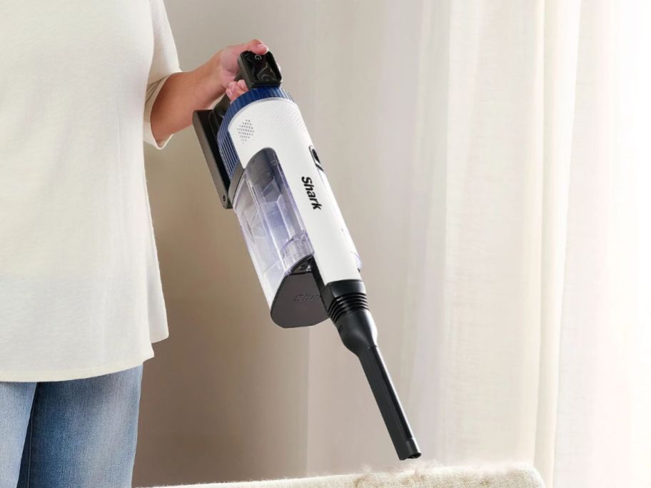 person using Shark CleanSense IQ Multi-Flex PowerFins IZ577 Cordless Vacuum on furniture