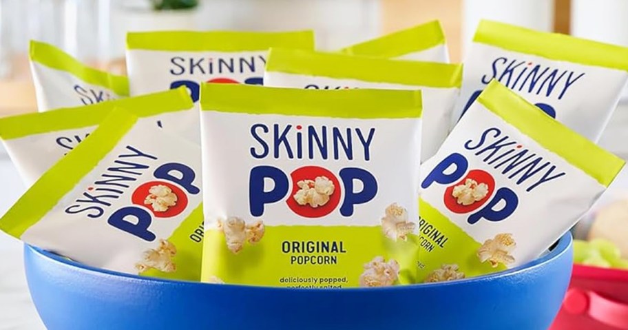 small bags of SkinnyPop Popcorn in a blue bowl