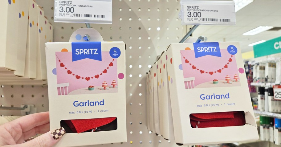 hand grabbing heart garland from store shelf