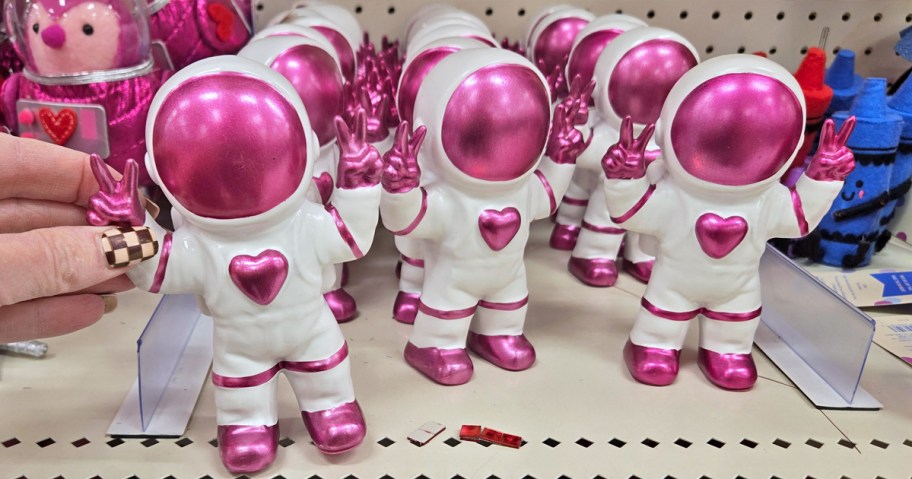 pink and white astronaut figures on store shelf