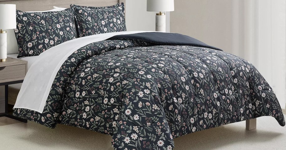 dark floral print comforter set on a bed