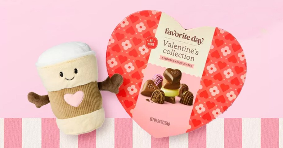 coffee plush next to a heart-shaped box of chocolates