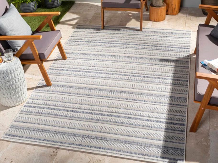 The Twillery Co. Mendota Bellino Striped Oatmeal 7'10" x 10'2" Area Rug on patio