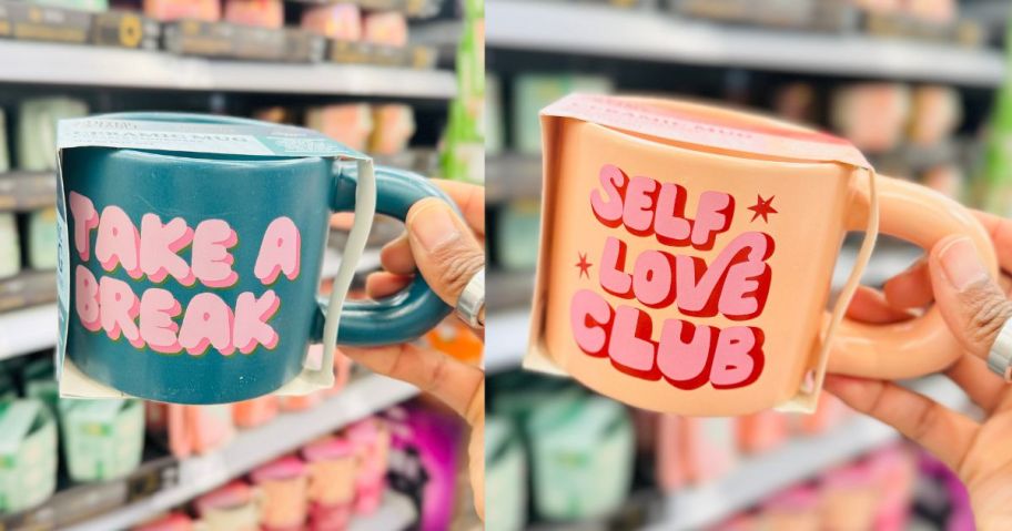 hands holding Thyme & Table Take a Break & Self Love Mugs in store