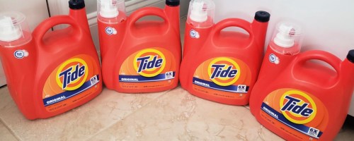 large bottles of tide detergent on floor