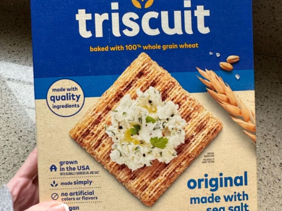 Hand holding a box of Triscuits