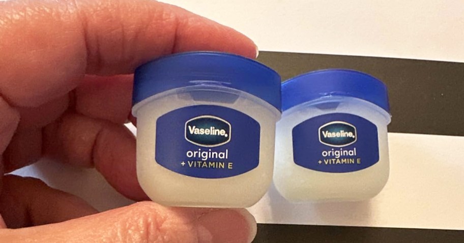 hand holding mini Vaseline Lip Therapy jars