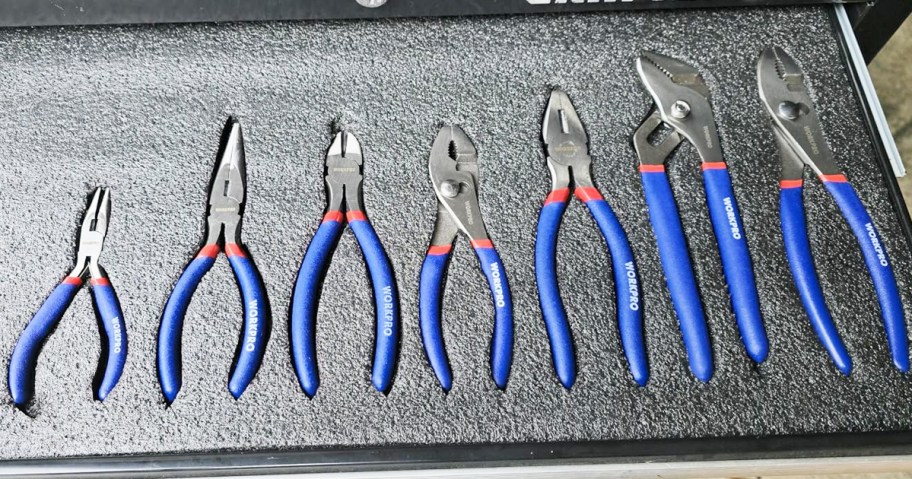 set of pilers with blue handles in a toolbox drawer
