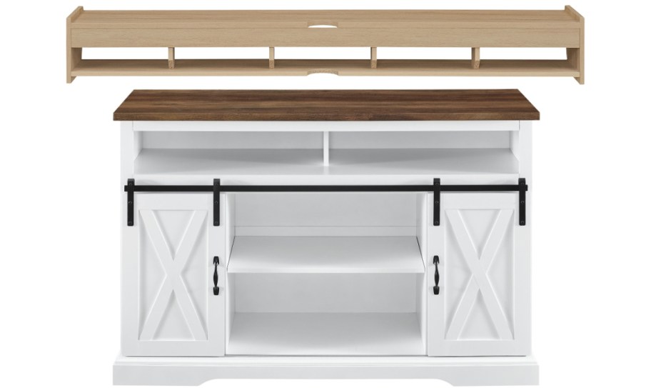 White farmhouse TV stand with a dark wood top, featuring sliding barn doors below, and a light wood floating shelf with multiple compartments above.
