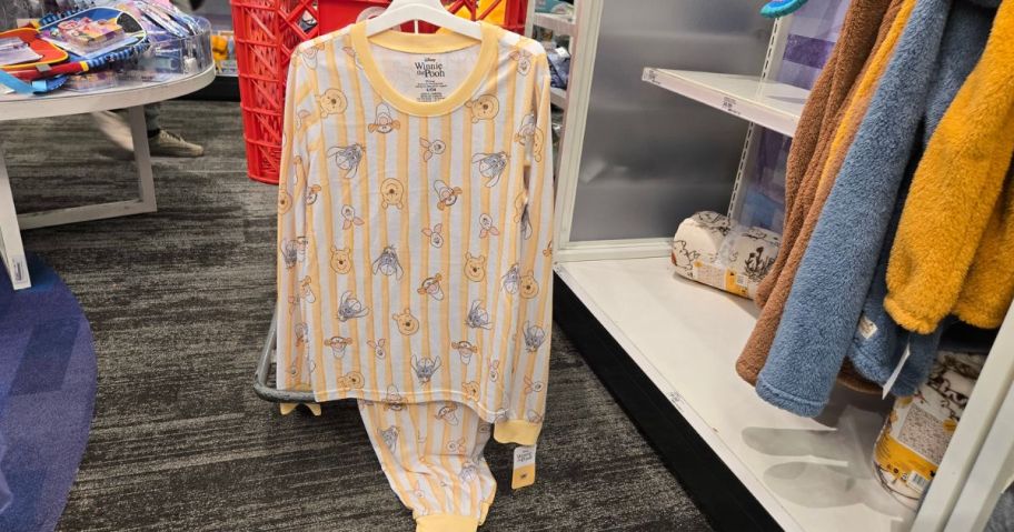 Winnie the Pooh Pajamas hanging from shipping cart