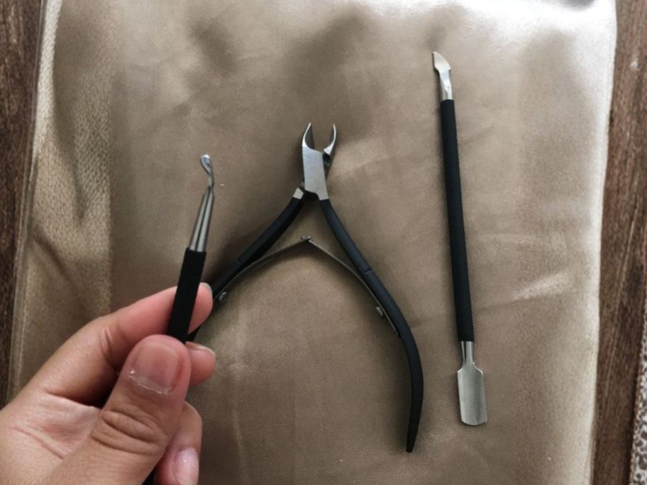 hand holding one piece of cuticle cutter set