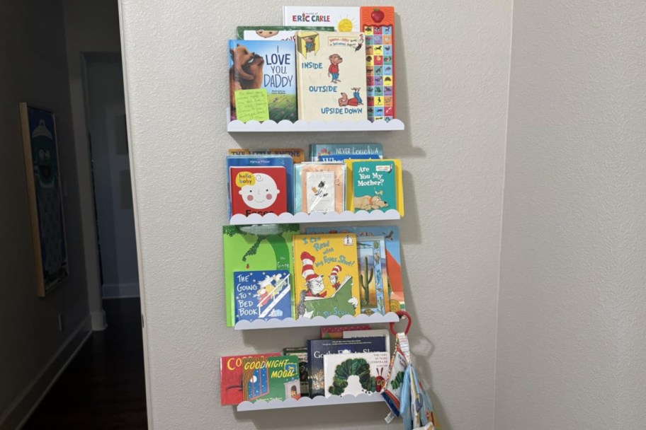 four white bookshelves with books on them