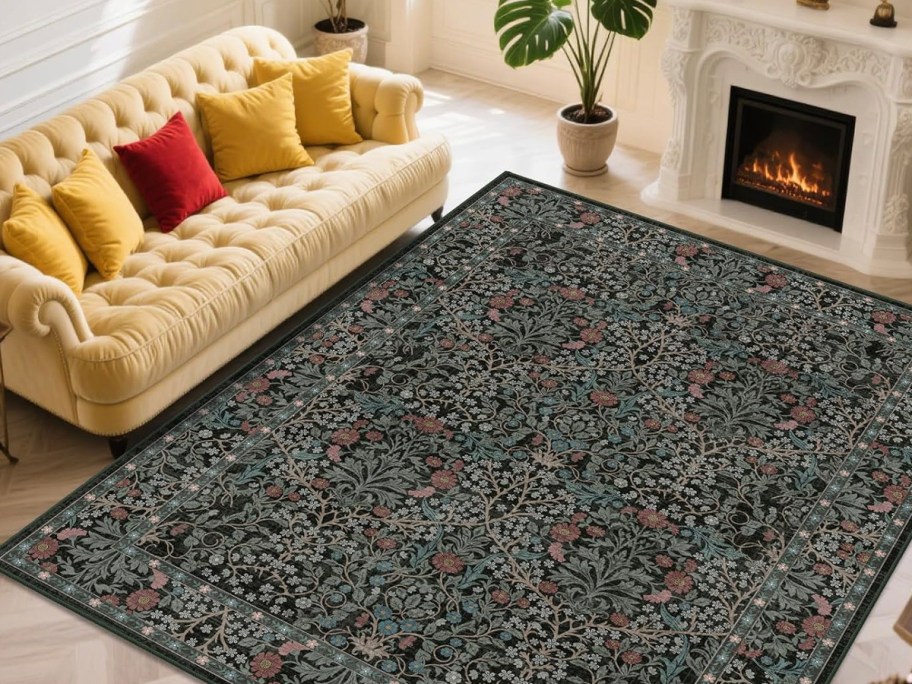 black rug in front of tan couch