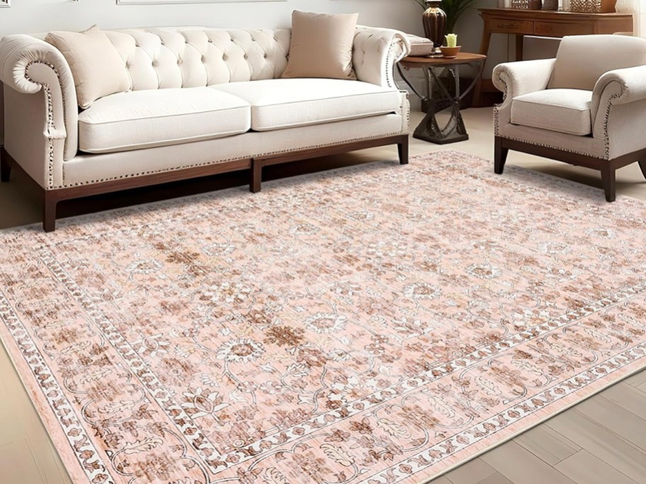 pink rug in front of white couch