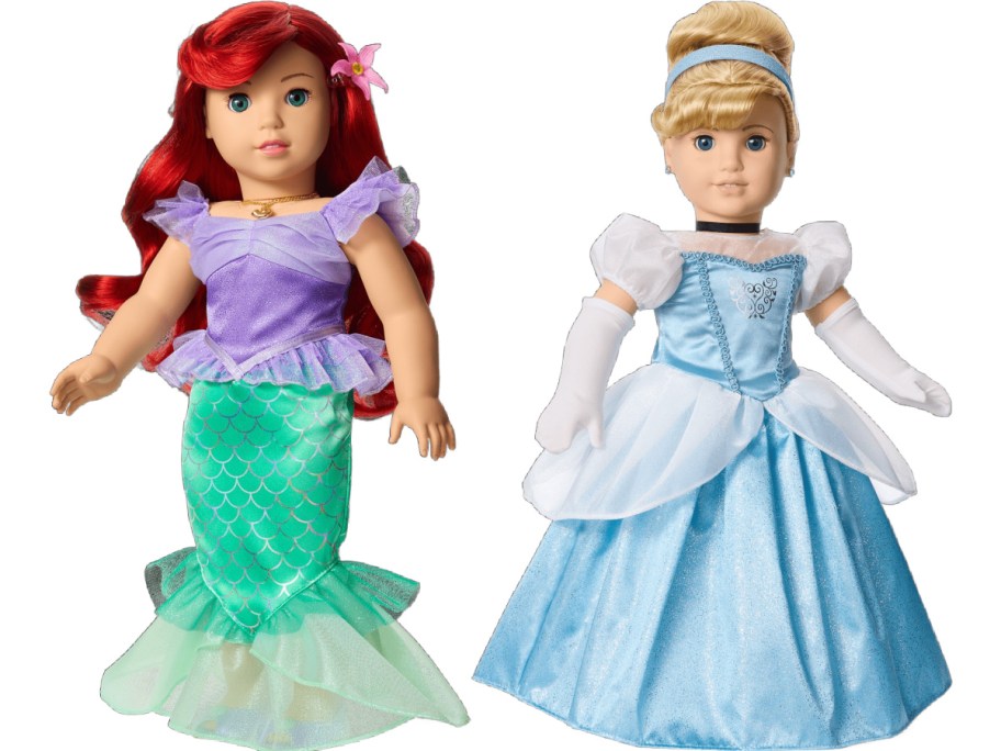 Two dolls dressed as princesses. One has red hair, a purple top, and green mermaid tail. The other wears a blue dress and gloves with blonde hair in a bun.