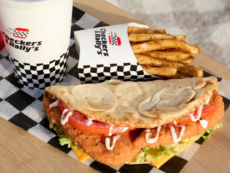 flatbread sandwich next to fries and a drink