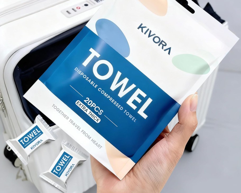 hand holding bag of compressed towels