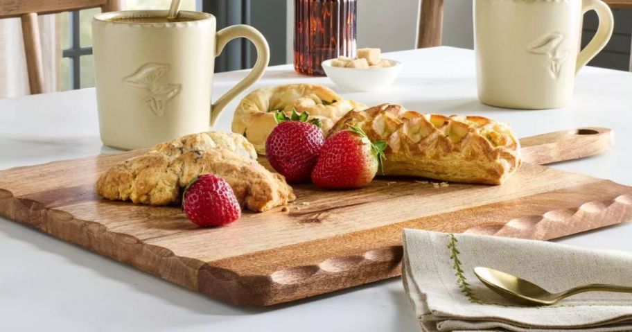 cutting board with food on it displayed on top of a table 