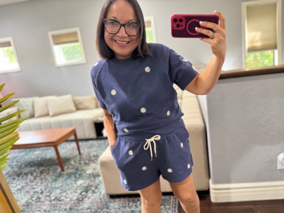 woman in navy blue lounge set taking selfie