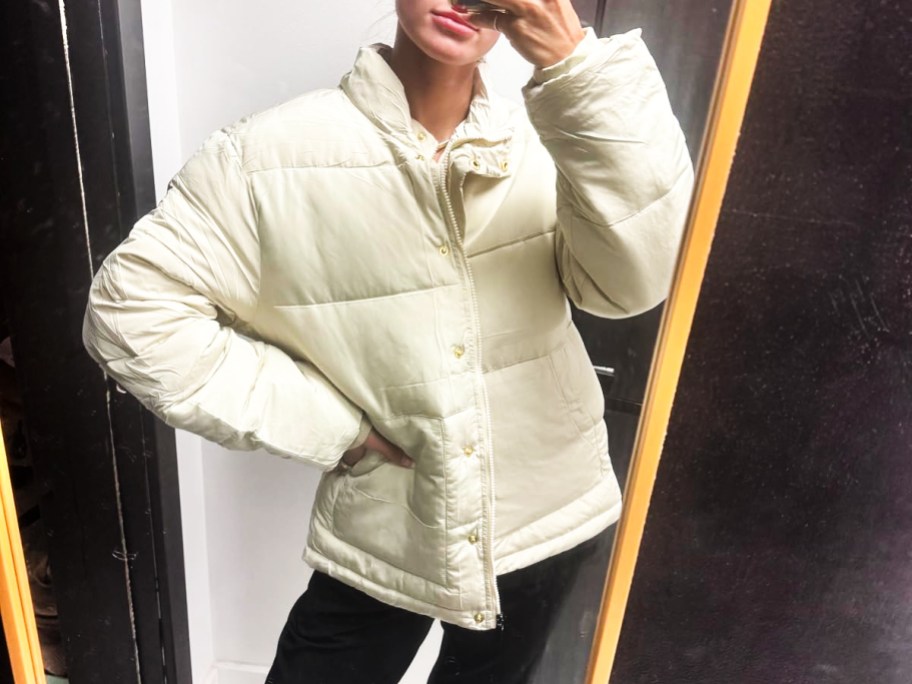 woman in white puffer jacket taking selfie