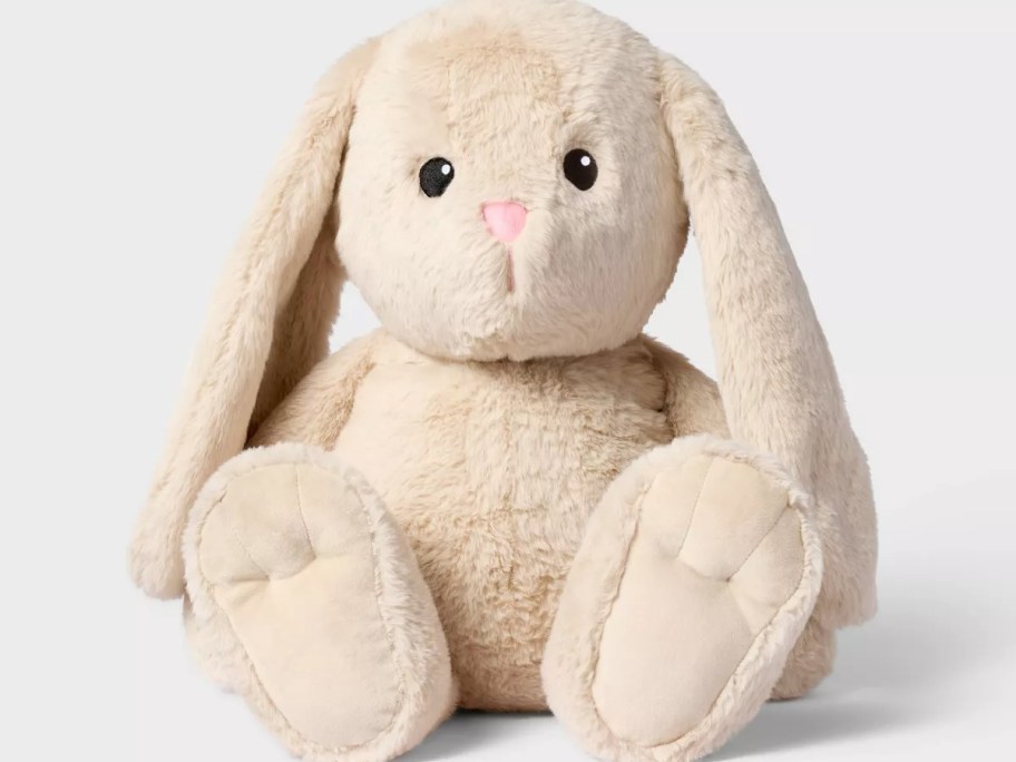Stuffed beige bunny with long ears and a pink nose, sitting upright.