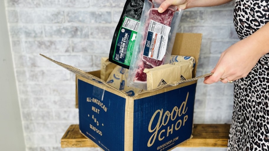 womans hand removing items from a box