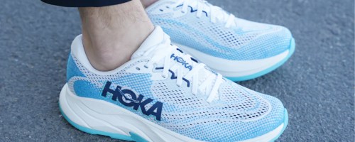 person wearing blue and white hoka shoes