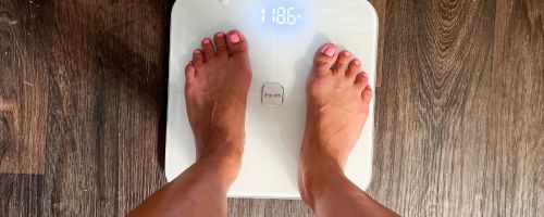 Woman's feet standing on a digital scale
